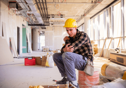 man sitting wearing a construction hat